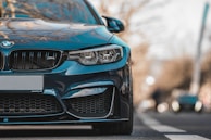 blue bmw m4 on road during daytime