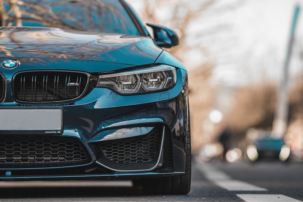 blue bmw car on road during daytime