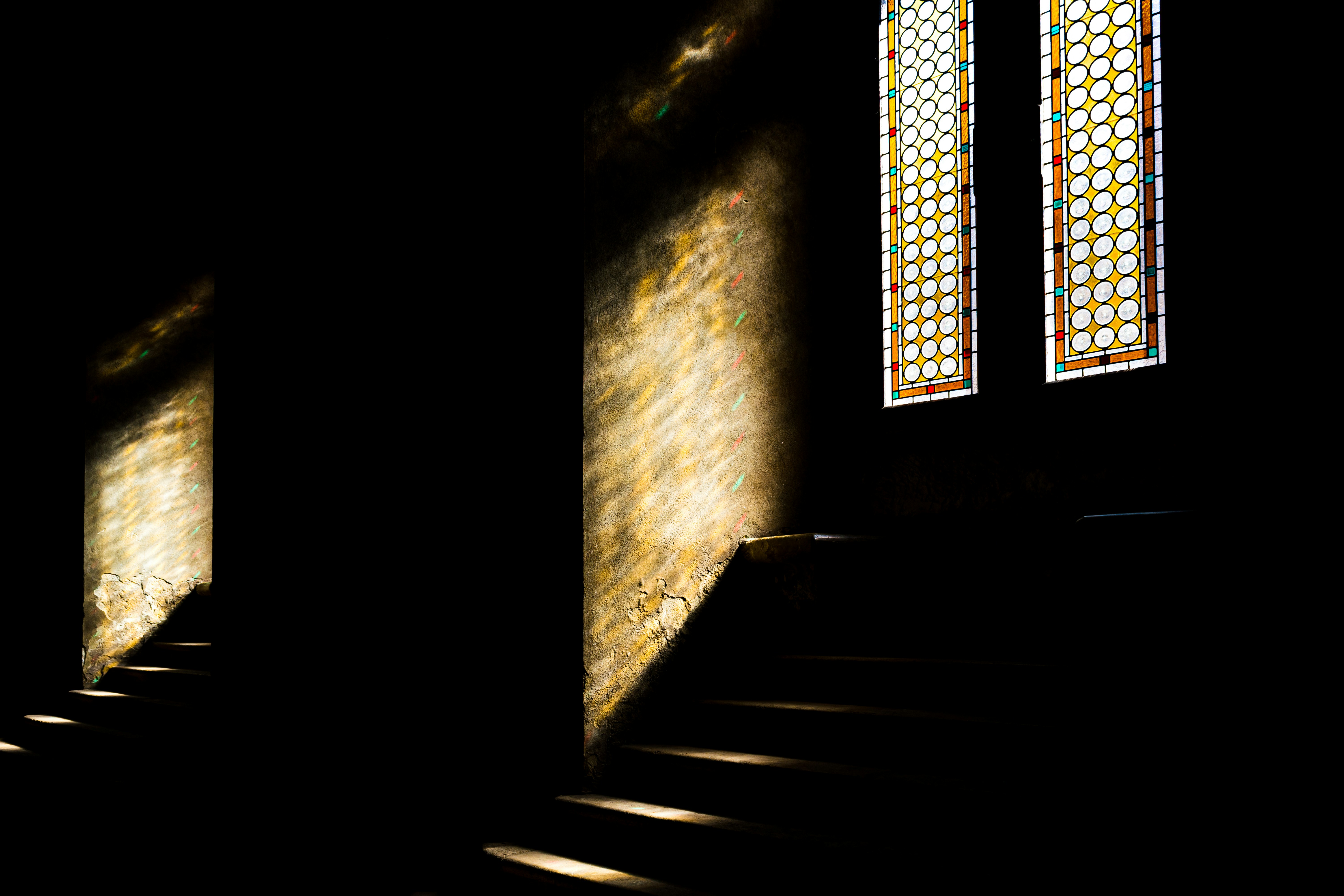 brown wooden staircase in front of brown concrete wall