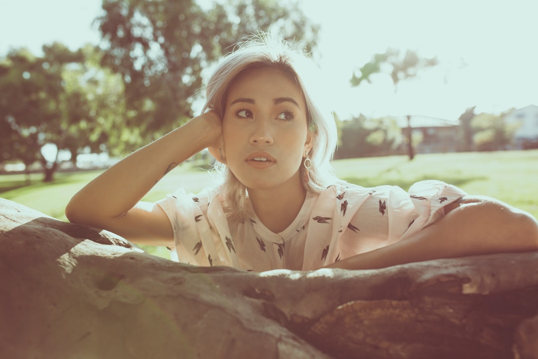 woman in white dress lying on brown rock