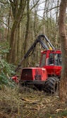 red and black tractor on green grass field