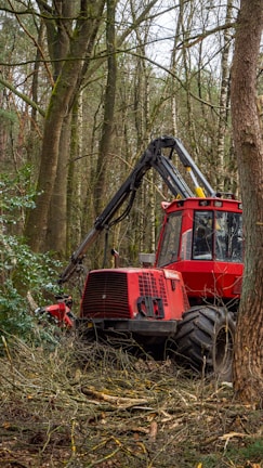 red and black tractor on green grass field