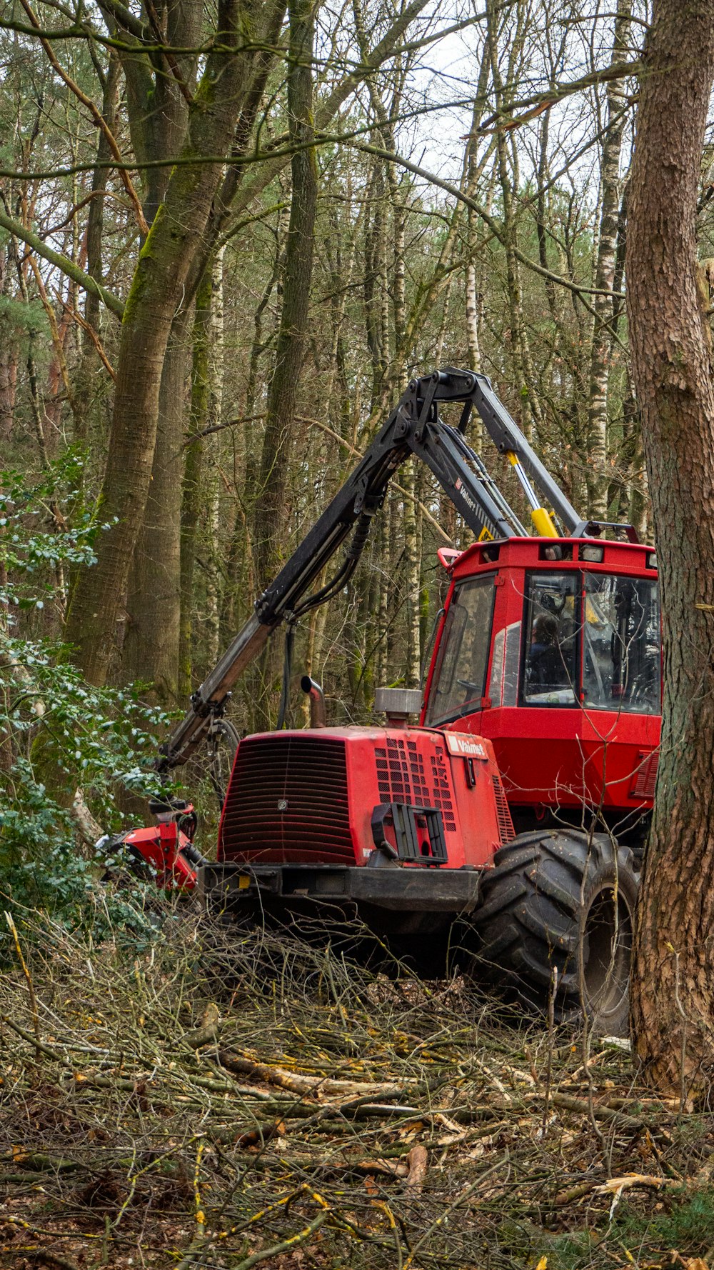 red and black tractor on green grass field