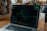 A close-up of a person using a laptop, focused on a digital growth chart on the screen.