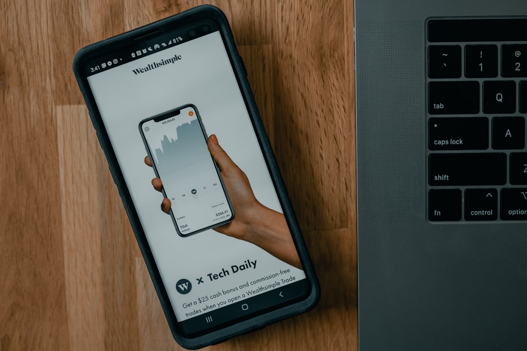 black samsung android smartphone on brown wooden table, Wealthsimple Investing App | Via techdaily.ca | #stocks #finance