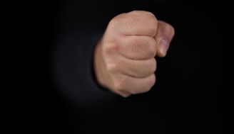 persons fist on black background