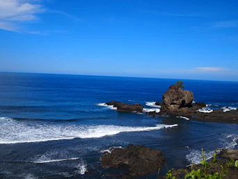 brown rock formation on sea during daytime