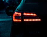 Set of LED car lights glowing brightly in a dark environment.