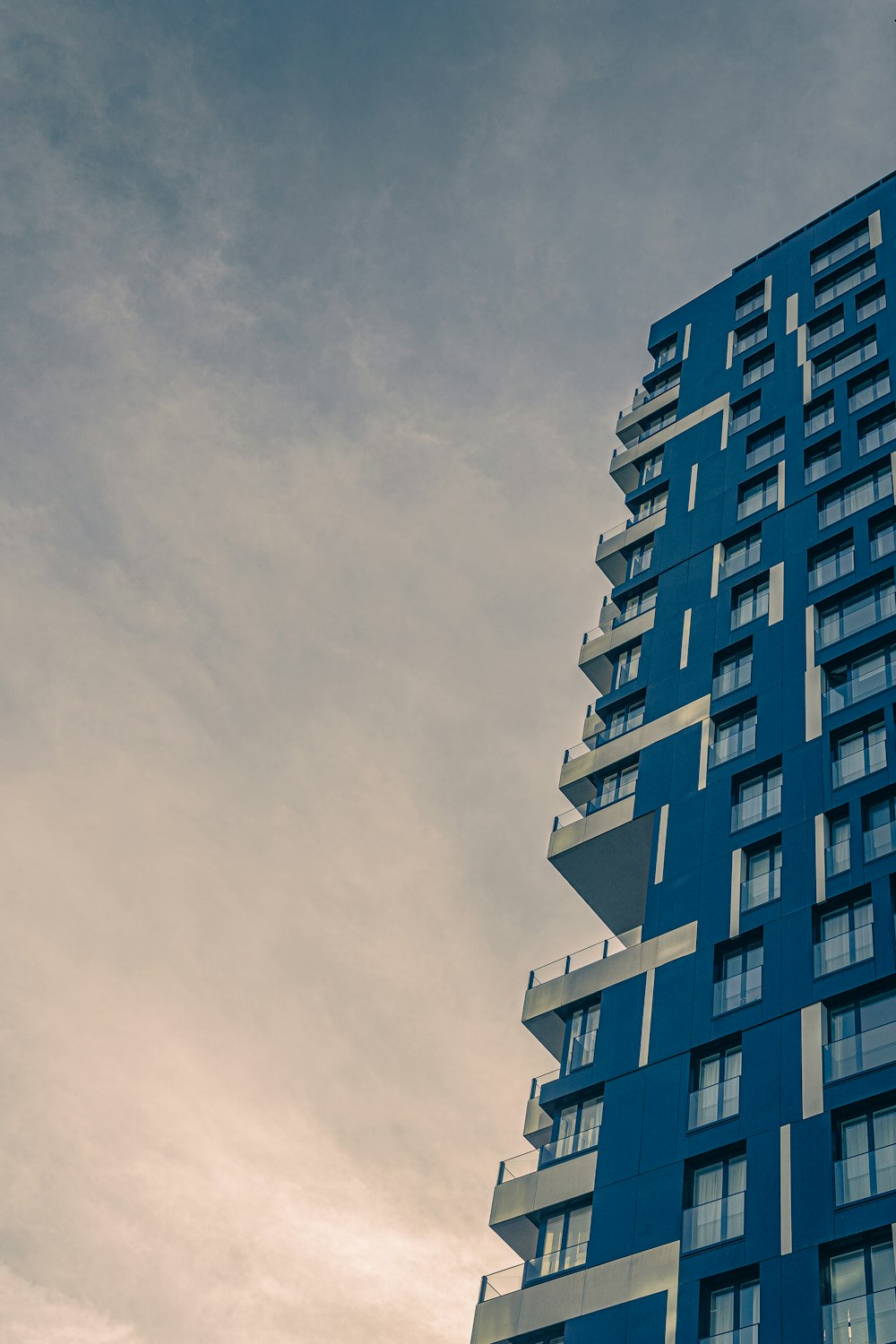 blue and white concrete building under white sky during daytime