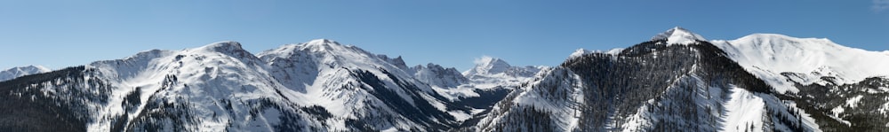 snow covered mountains under blue sky during daytime