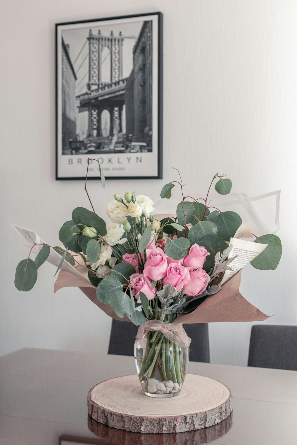 pink and white roses in clear glass vase