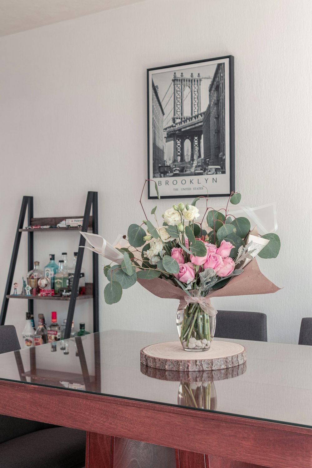 pink and white roses in clear glass vase