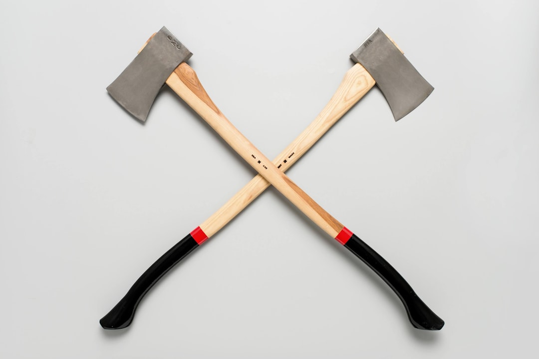 brown wooden cross on white background, Wooden firefighter axe cross symbol