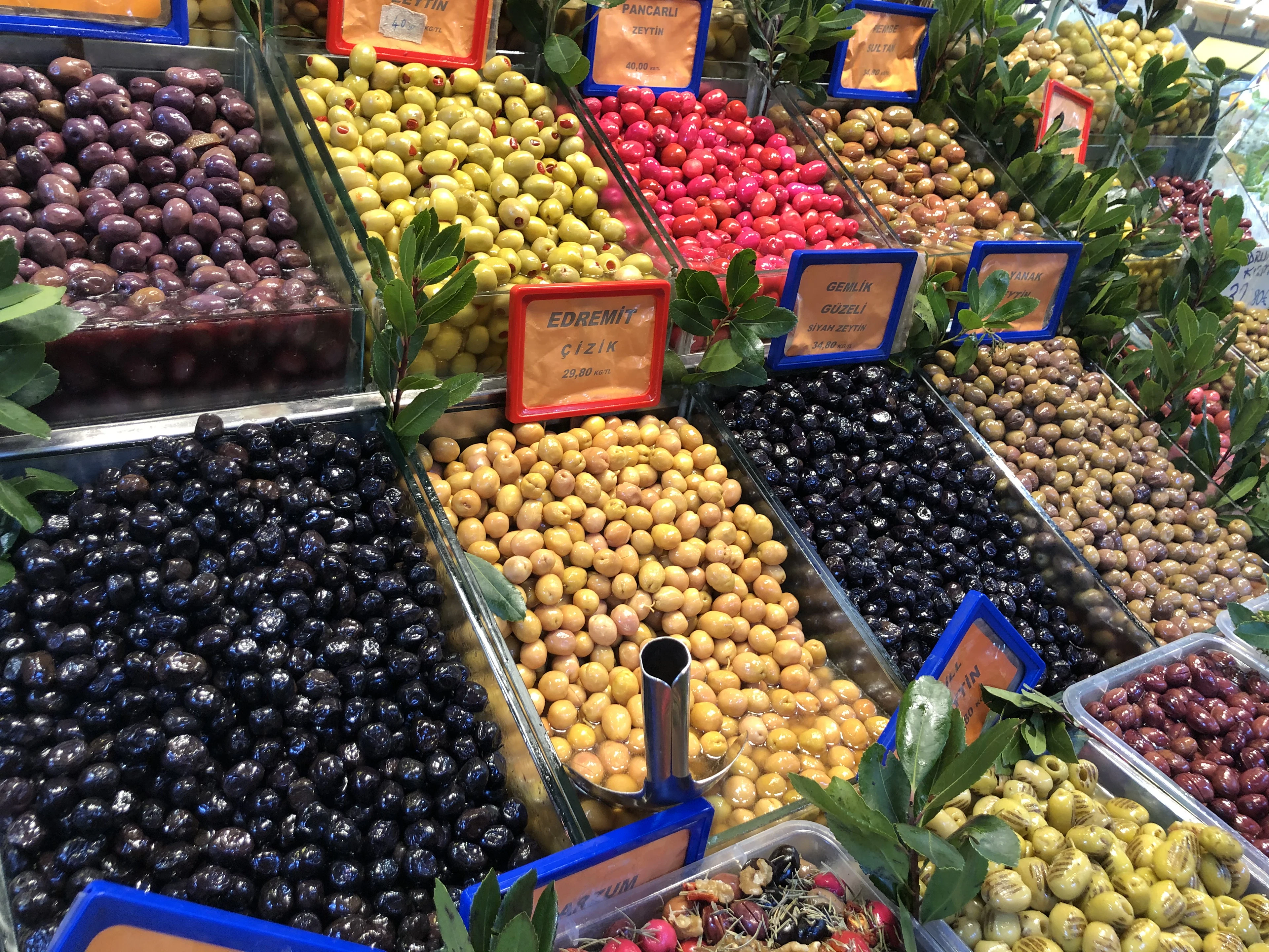 Black, green and red olives in a trader's crates at the Kadıköy market