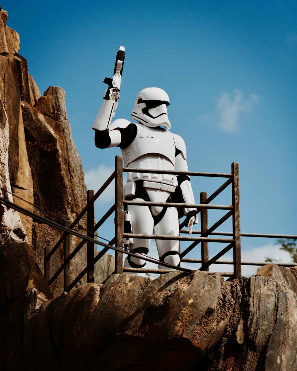 white and black robot on brown rock formation during daytime