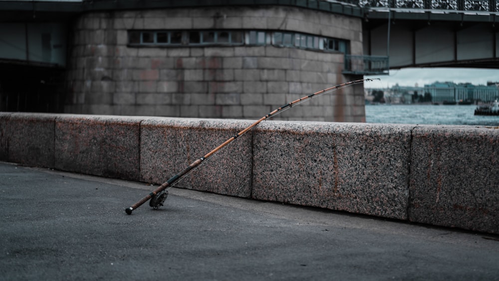 black and red fishing rod on gray concrete floor