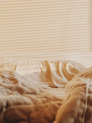 A close-up of a mattress with a protective cover being applied to prevent bed bugs.