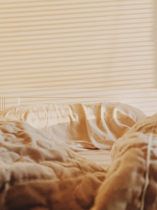 A close-up of a mattress with a protective cover being applied to prevent bed bugs.