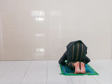 Elegant prayer mat with intricate patterns laid out in a serene prayer space.