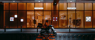 A sleek banner ad space integrated into a news website layout with Hermes motifs.