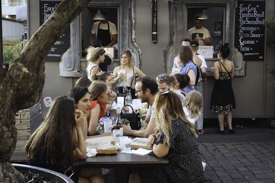 people sitting on chair in front of table
