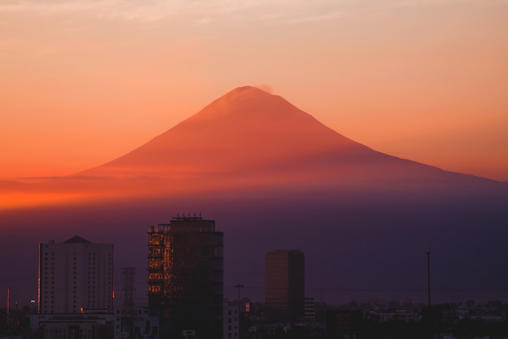 silhouette of mountain under cloudy sky during daytime