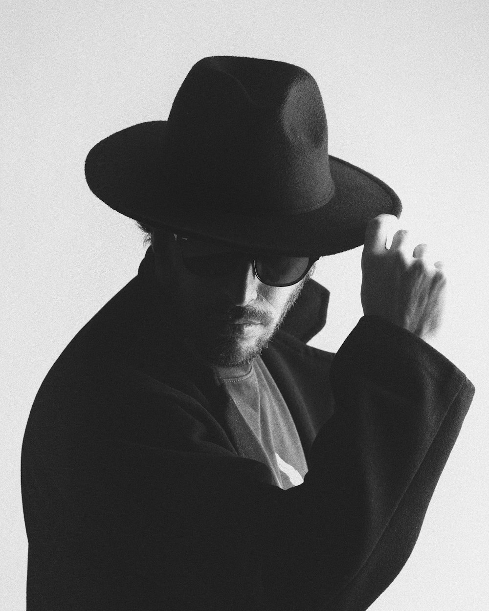 man wearing black hat and black coat