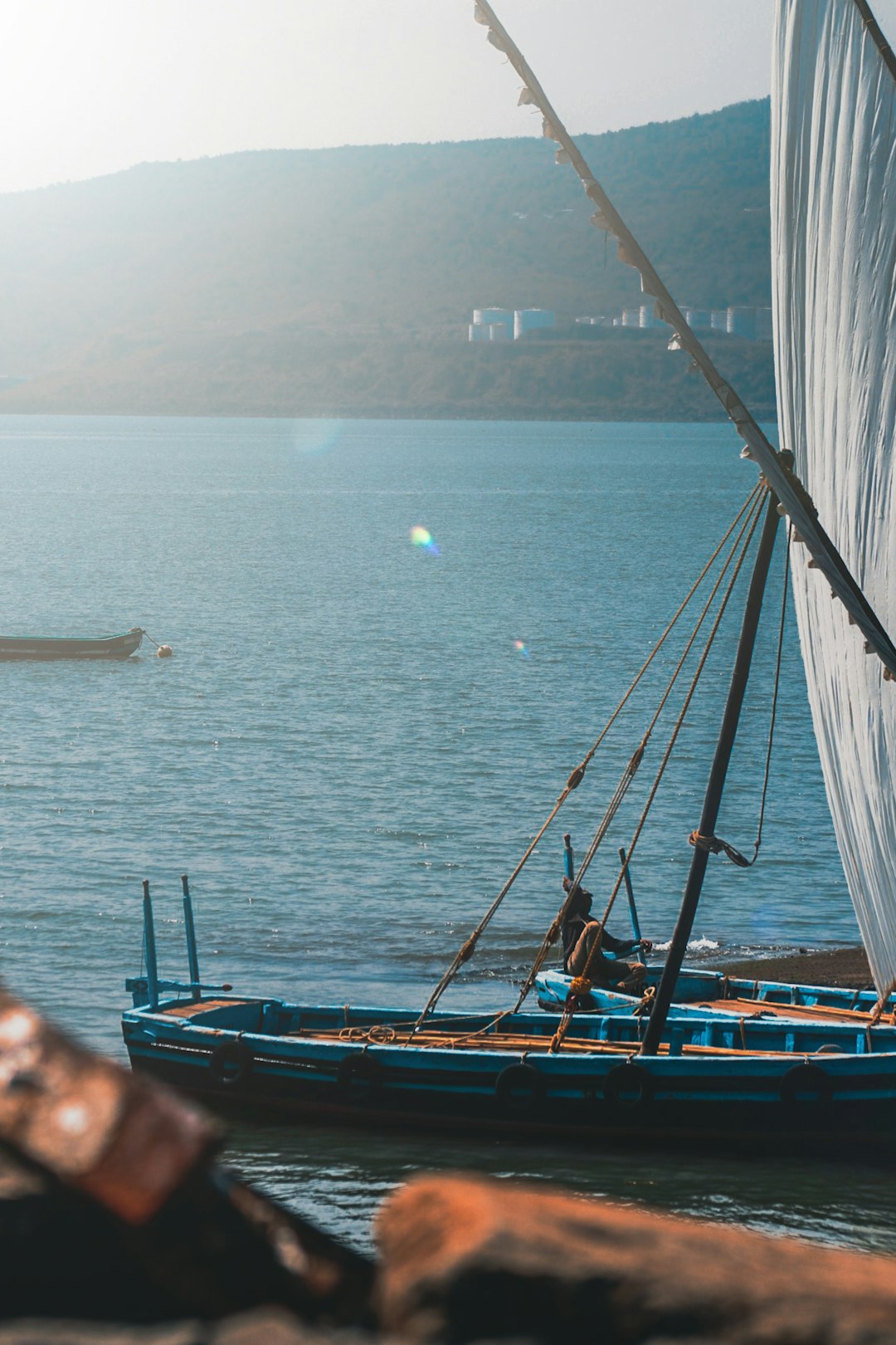 brown and blue boat on sea during daytime