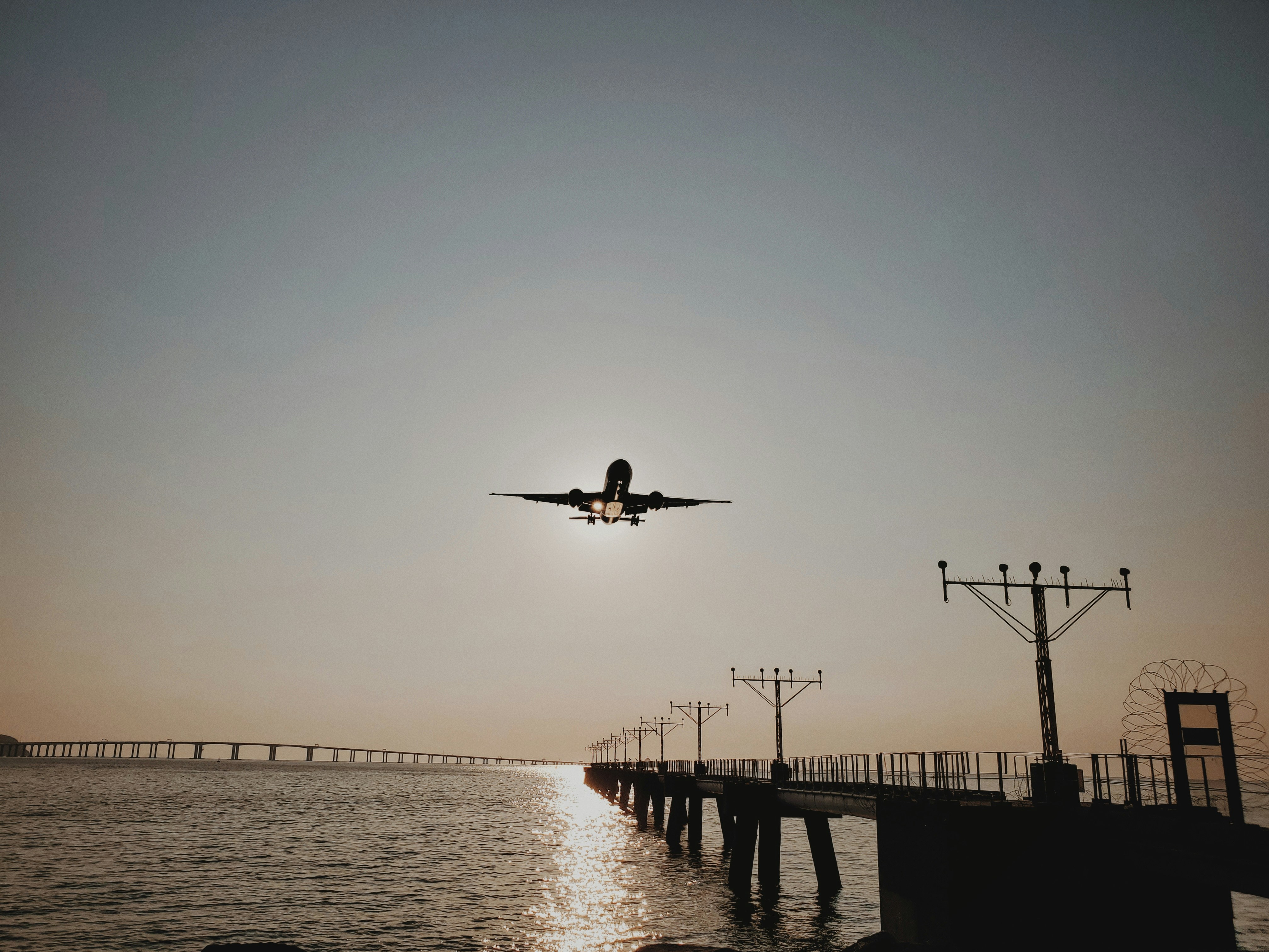airplane flying over the sea during daytime