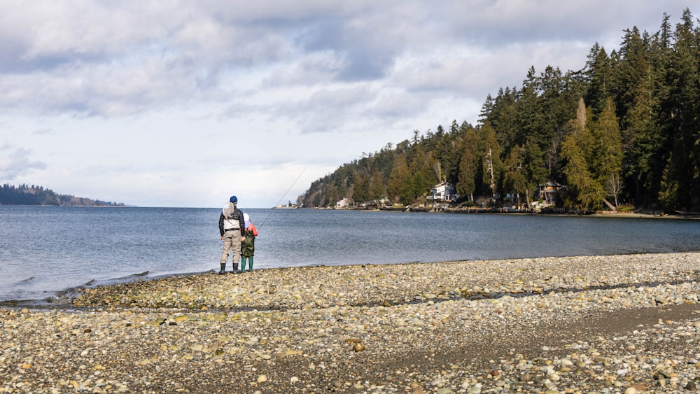 hombre y mujer caminando en la playa durante el día