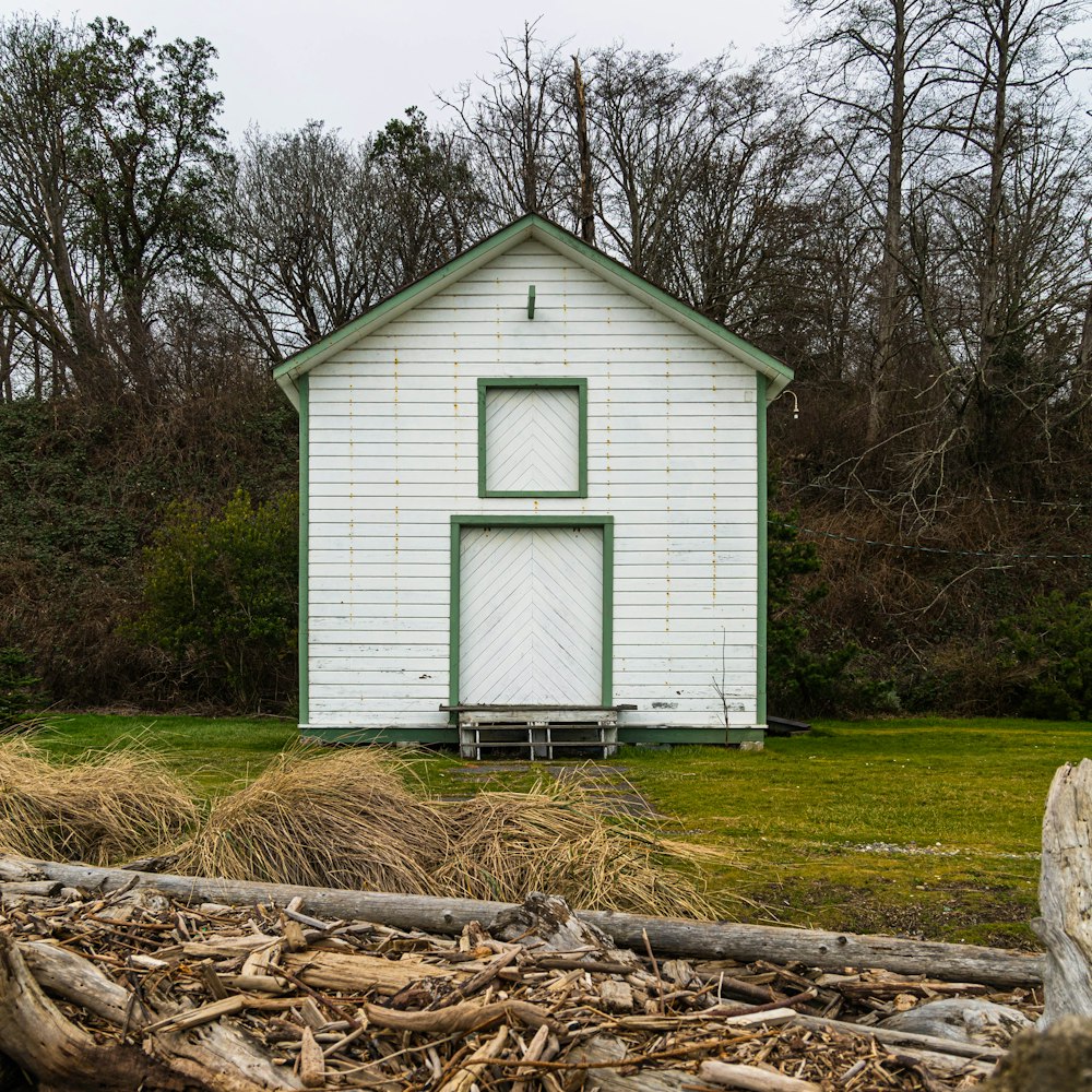 white wooden house near brown tree log