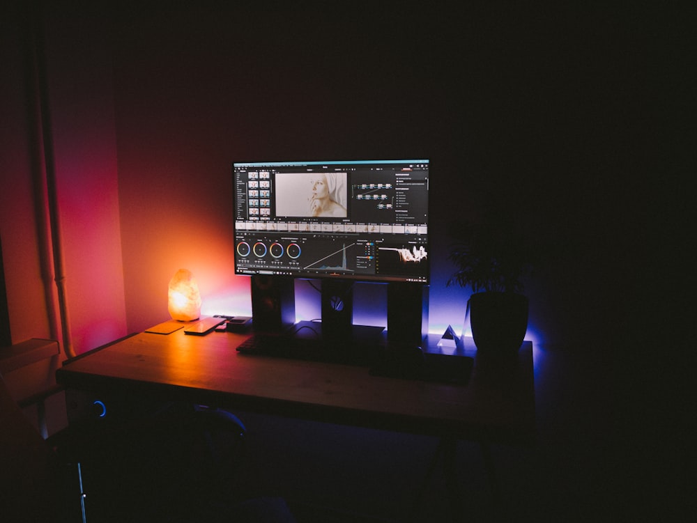 black flat screen computer monitor turned on beside black computer keyboard