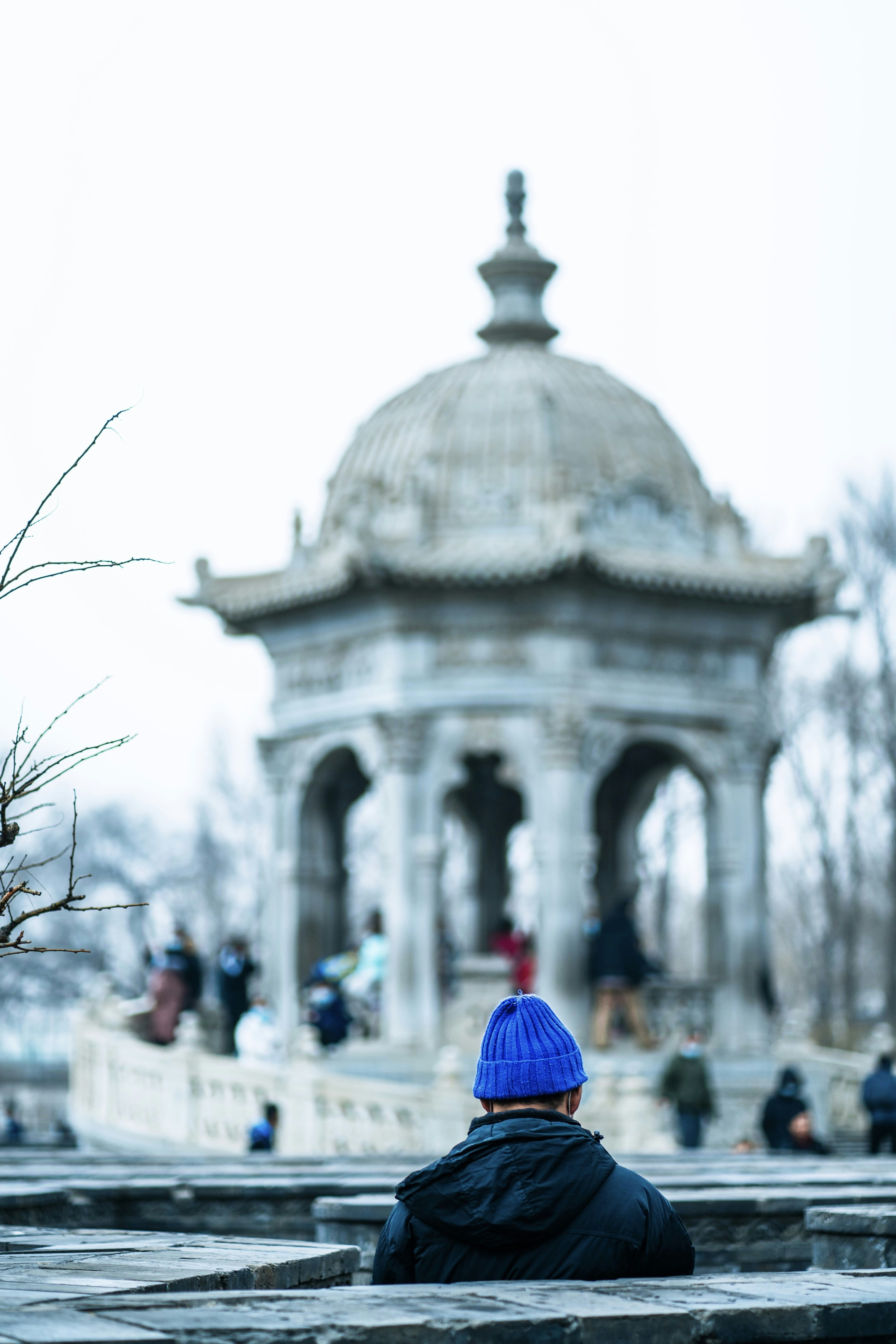 people walking on street near white concrete building during daytime