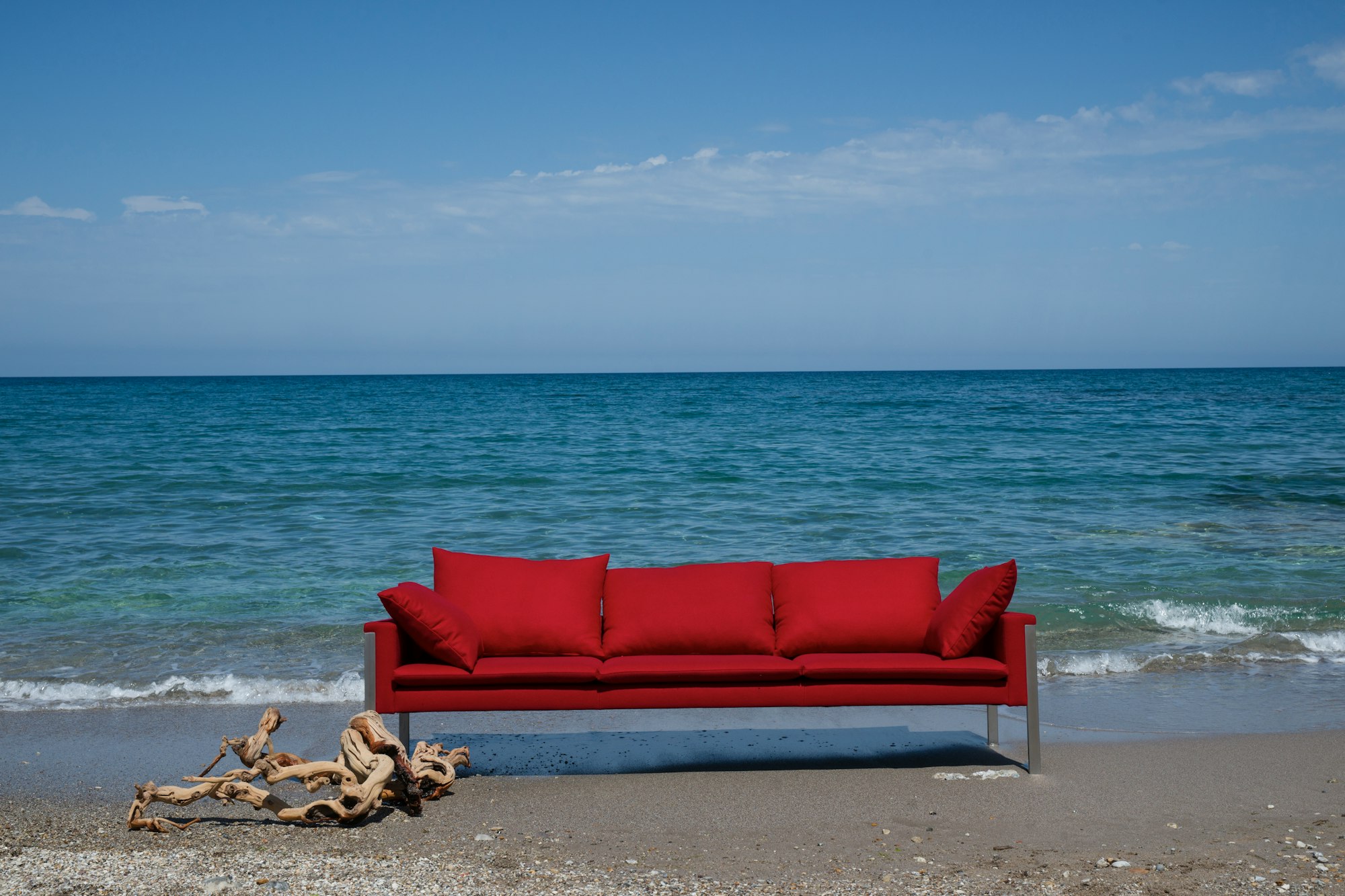 red padded couch on beach shore during daytime