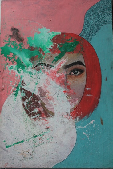 A stylized portrait of a person with vibrant red hair and a striking eye is overlaid with abstract splashes of green and white paint. The background features shades of pink and teal with a textured pattern in the upper right corner. The composition blends realism with abstract expressionism, creating a visually dynamic work.
