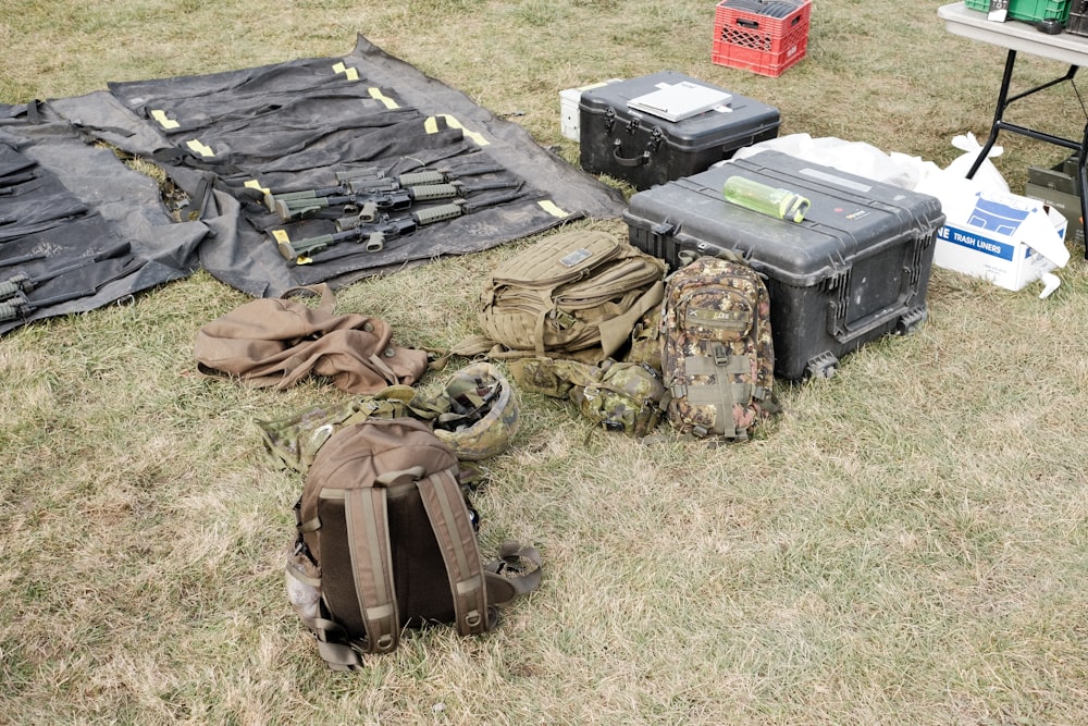 black and gray backpack on green grass field