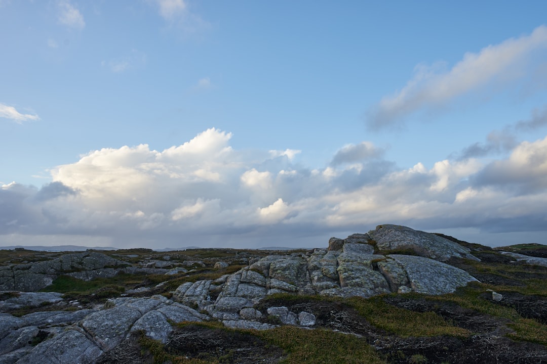 gray rocky mountain under white clouds during daytime