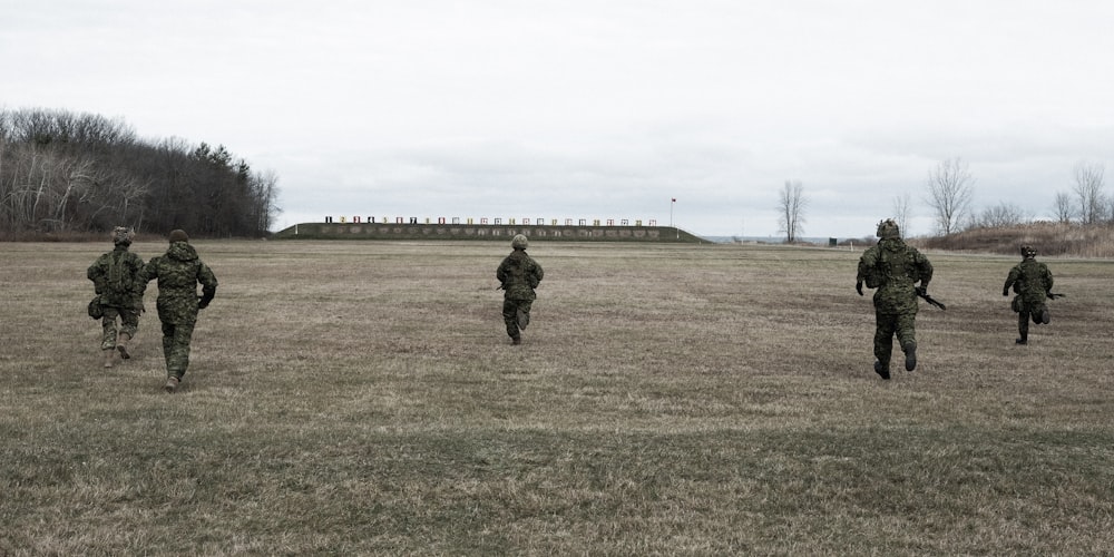 man in black jacket walking on green grass field during daytime