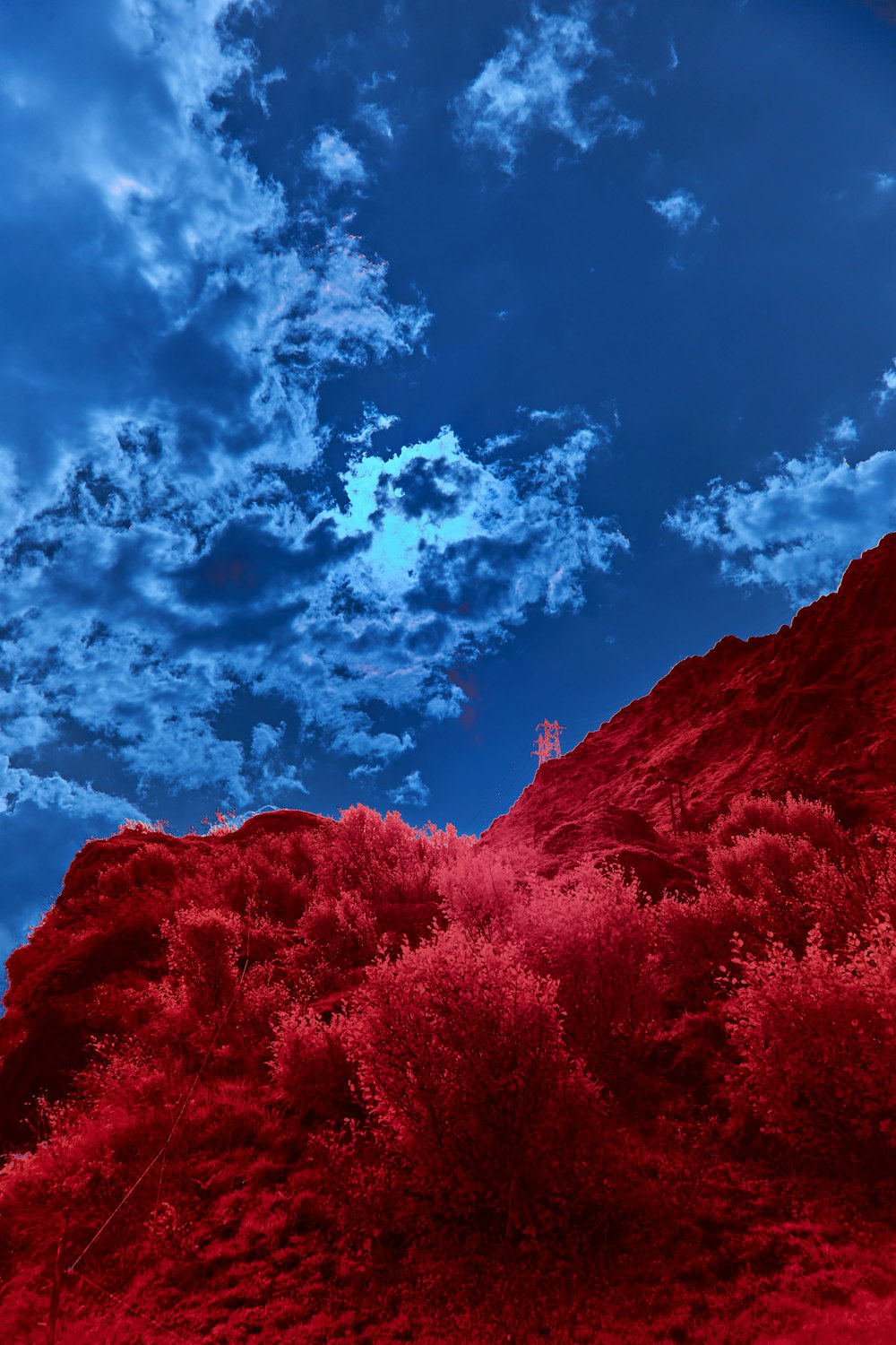 brown mountain under blue sky and white clouds during daytime