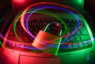 A focused professional studying cybersecurity concepts on a laptop with digital security icons floating around.