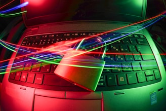 black laptop computer turned on with lights