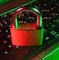 red padlock on black computer keyboard