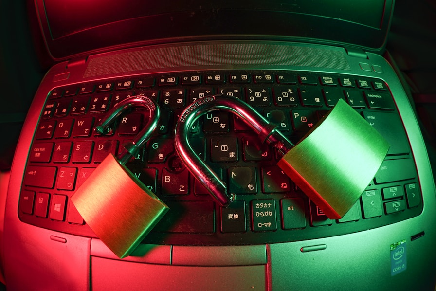 Two padlocks open on top of a laptop keyboard