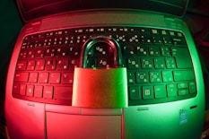 pink and silver padlock on black computer keyboard