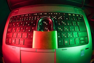 pink and silver padlock on black computer keyboard