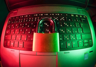 pink and silver padlock on black computer keyboard