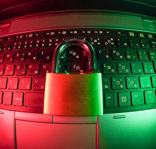 pink and silver padlock on black computer keyboard