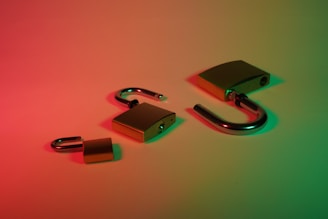 green and silver padlock with keys