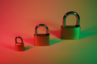 two brown padlock on pink surface
