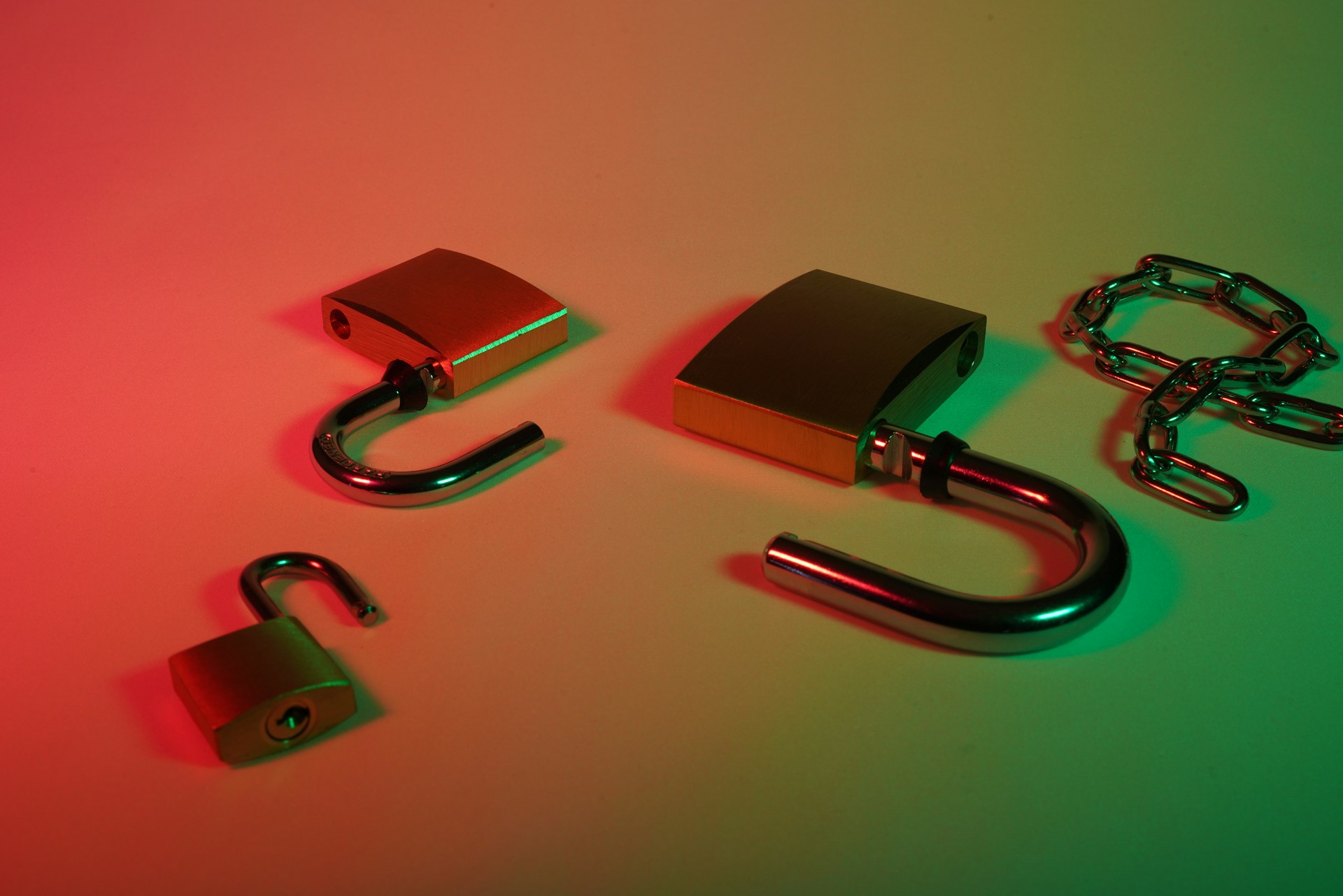 green and silver padlock on pink surface